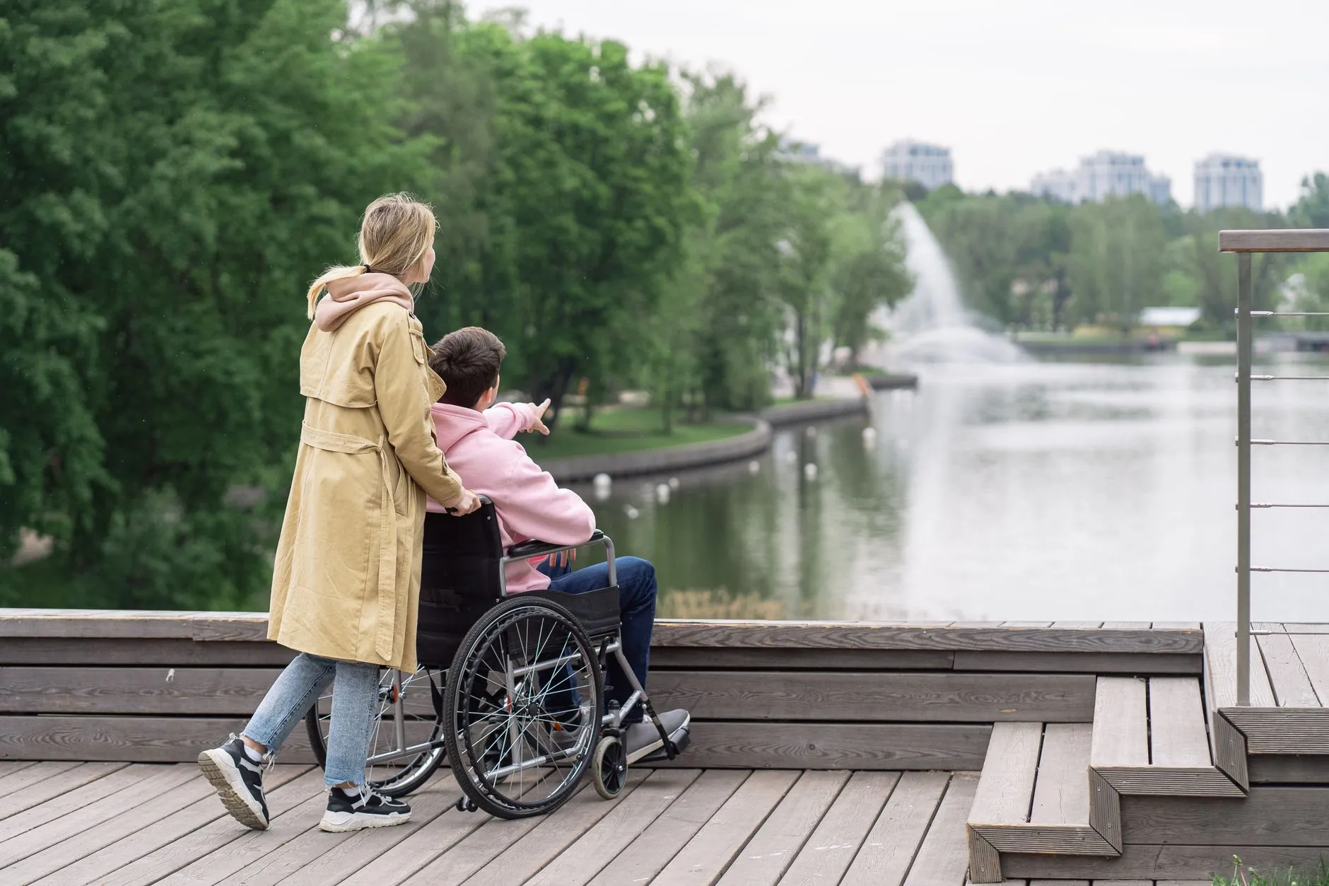 A support worker and a participant sharing a warm moment beside a lake on the Mornington Peninsula